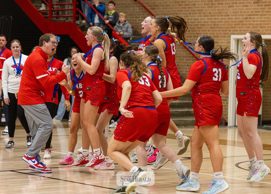 Samantha McGaffee photo/HBCGBB5 H-BC head coach Dylan Gehrke cheers with the team after receiving their sub section final medal in Worthington. H-BC beat MCC 48-40 in the game to move on in the section tournament.