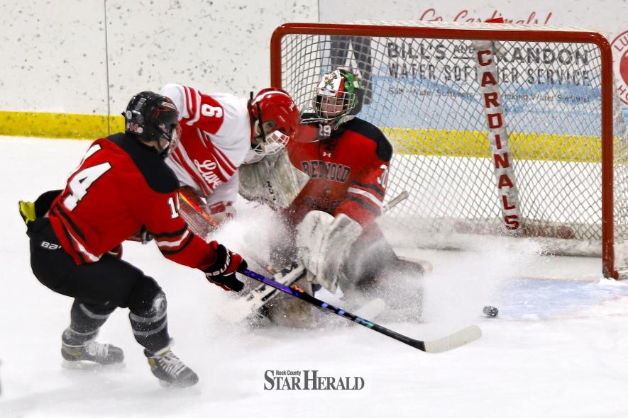 LHS junior Blake Sauer tries to play the puck in front of the net as it passes Redwood Valley’s goalie Thursday, Jan. 16, at home. Luverne beat Redwood Valley 8-1.