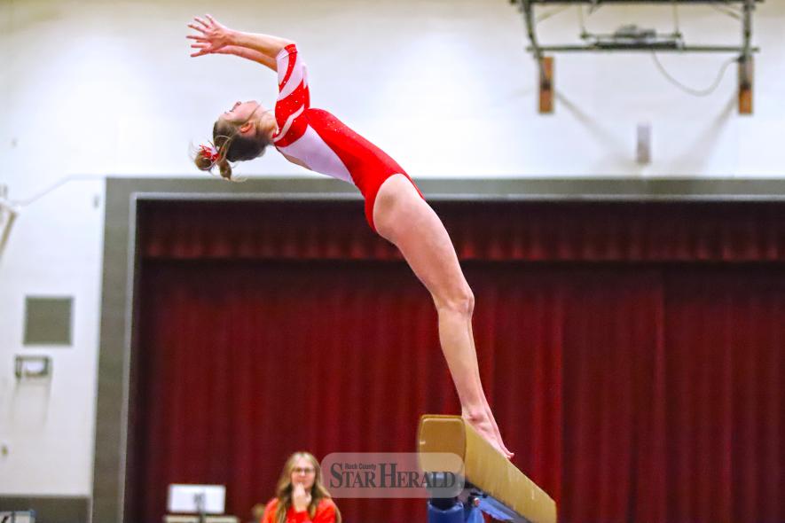 LHS senior Kendra Thorson dismounts from the beam with a back flip to the side of the apparatus Tuesday, Jan. 14. Thorson took third on the beam with a score of 7.500.