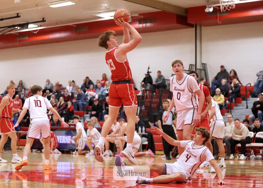 Greg Hoogeveen photo/LHSBBB1 LHS senior Jaydon Johnson jumps over a Fairmont player for a basket Tuesday, Dec. 2, at home. Johnson scored 24 points in a 66-64 win against Fairmont.