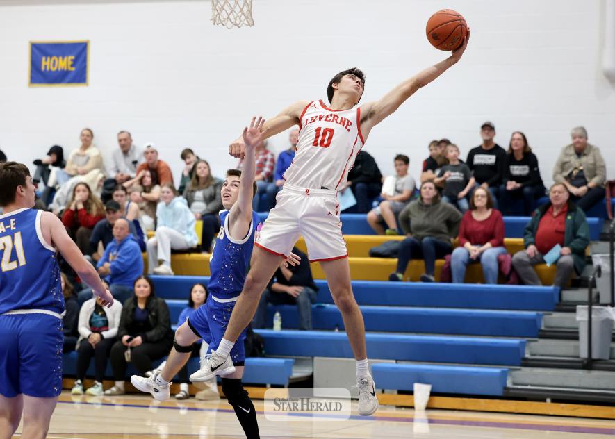 Greg Hoogeveen photo/LHSBBB1 LHS junior Coy Thone reaches for a high pass under the hoop on the road Monday, Dec. 22, against Adrian-Ellsworth. Thone finished with 22 points in the 86-39 win over the Dragons.