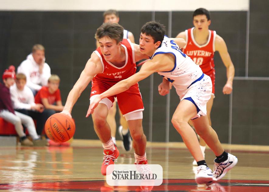 Cardinal senior Carter Sehr and an Eagles player stretch to gain control of a loose ball Thursday, Jan. 30, in Luverne. LHS beat Southwest Minnesota Christian 80-54.