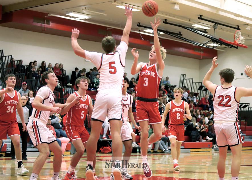 LHS senior Trevor DeBates works a one-handed shot into the rim against St. James Friday, Jan. 24, in Luverne. The Cardinals beat the Saints 97-51 in the game.