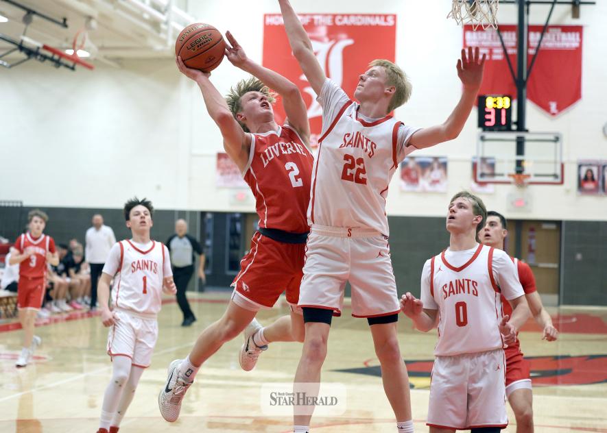 Greg Hoogeveen photo/LHSBBB3 Cardinal senior Connor Bose looks to the rim as he jumps toward the basket against St. James Feb. 27 in Luverne. LHS beat the Saints 79-67 in the game.