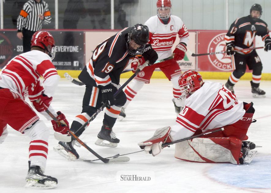 Greg Hoogeveen photo/LHSBHOC1 LHS senior goalie Gavin Hoven reaches to block a shot from Marshall in front of the Cardinals’ goal. Hoven directed away 14 of 14 shots in the game for a Luverne 3-0 win at home Dec. 4.