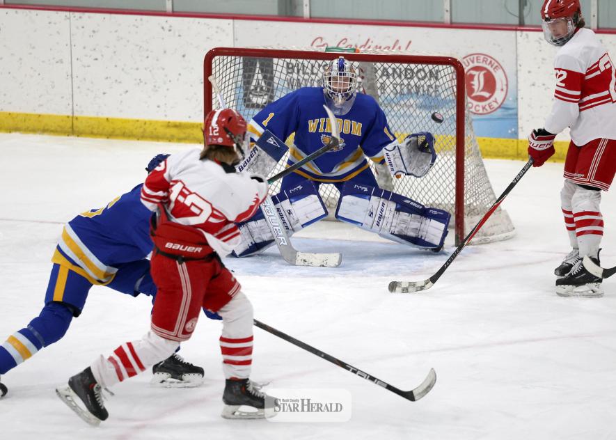 Greg Hoogeveen photo/LHSBHOC1 Cardinal sophomore Mallachi Domagala sends a puck topside toward Windom’s goalie Dec. 16 at home. LHS beat Windom 9-1 in the contest.