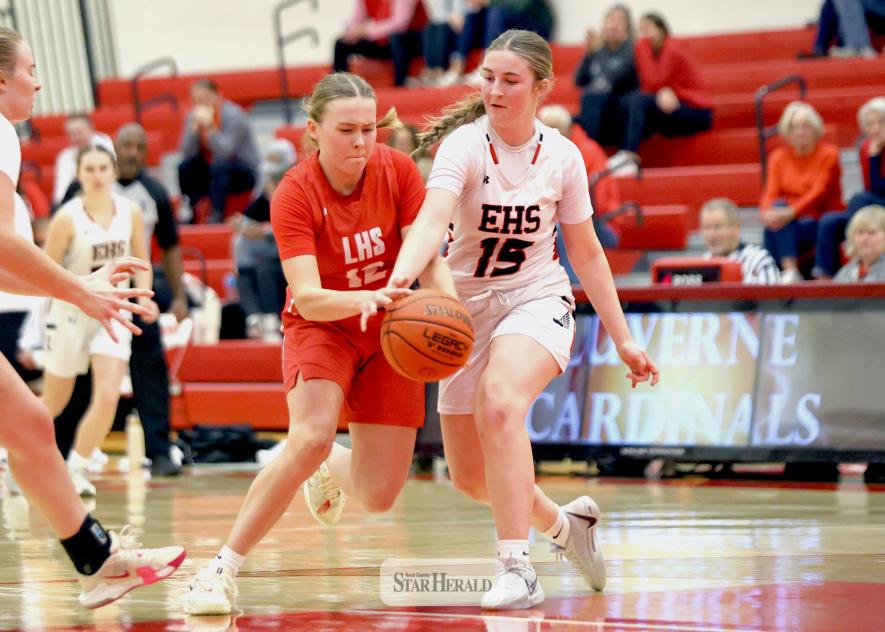 Cardinal junior Hannah Cowell fights through two Edgerton players as she heads toward the basket Nov. 24, at home.  Luverne won the home opener game 67-40.