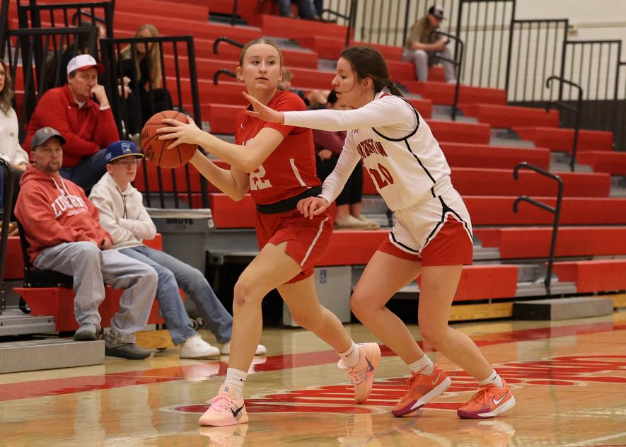 Greg Hoogeveen photo/LHSGBB2 LHS junior Mariah Knorr looks to pass the ball as the Cardinals cross the center line at home Feb. 12. Knorr finished with nine points against the Trojans as LHS won the game 84-46.