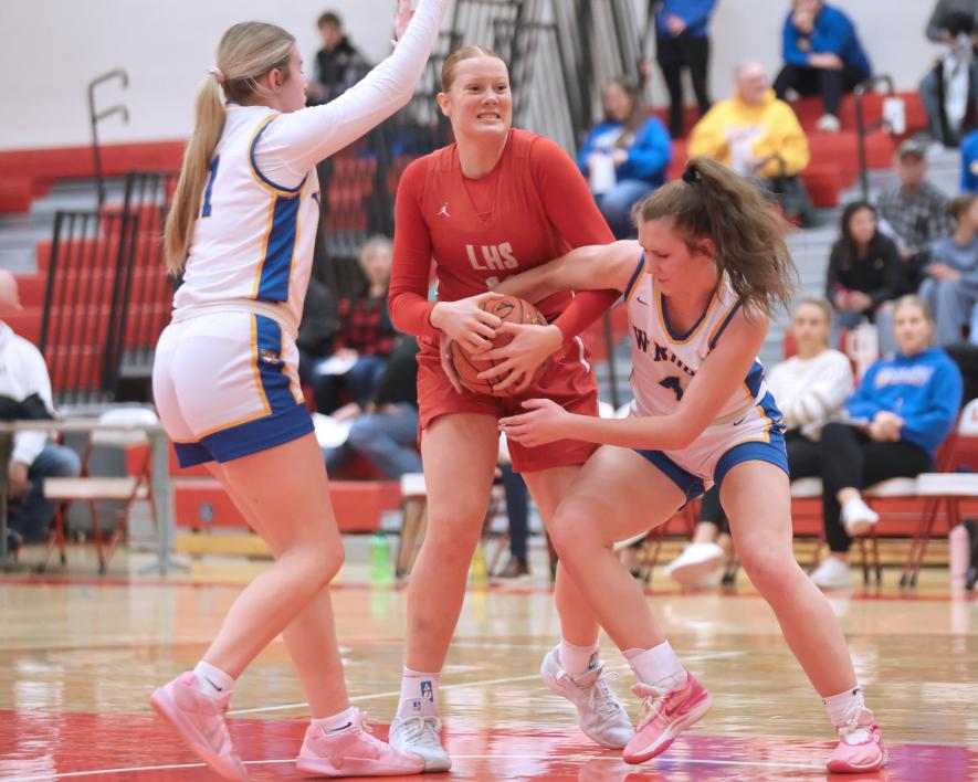 LHS freshman Taya Johnson tries to fight off two Windom opponents under the hoop as she tries to gain control of the ball. LHS fell 79-38 to the Eagles at home Friday, Feb. 7. Greg Hoogeveen/Rock County Star Herald Photo