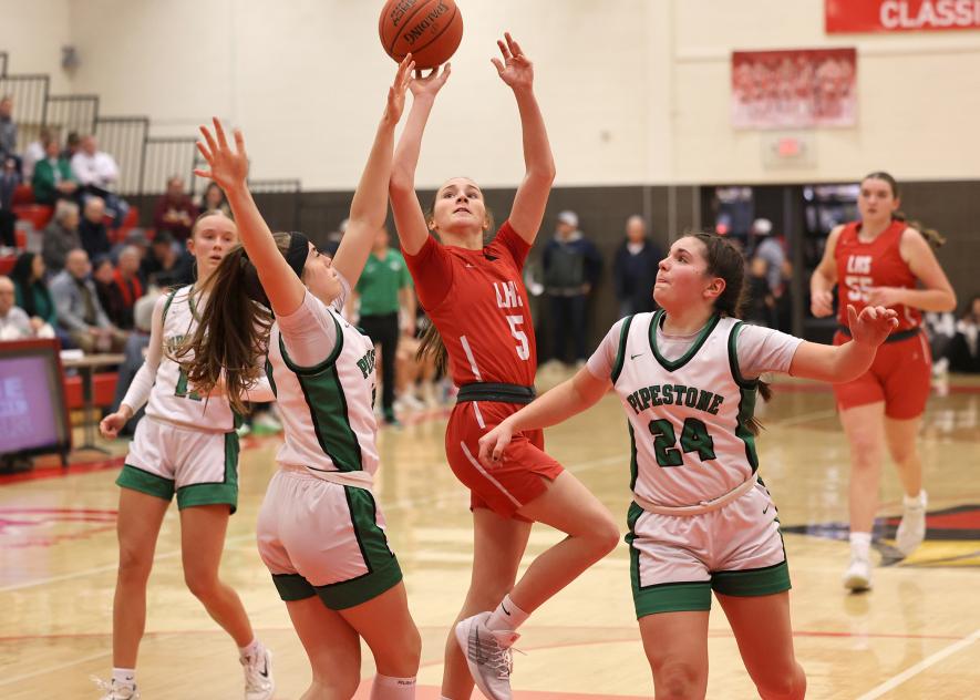 Greg Hoogeveen photo/LHSGBB3 Cardinal eighth-grader Ingrid Schmuck extends past a Pipestone player to make a shot at the basket on a fast break. LHS fell 70-59 in the game Tuesday, Jan. 27, in Luverne.