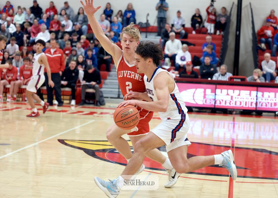 Greg Hoogeveen photo/LHSHBC1 Luverne senior Connor Bose, No. 2 in red, and H-BC senior Micah Bush tangle as Bush drives the ball up court Thursday, Feb. 19, in Luverne. LHS beat the Patriots 70-67 in the game.