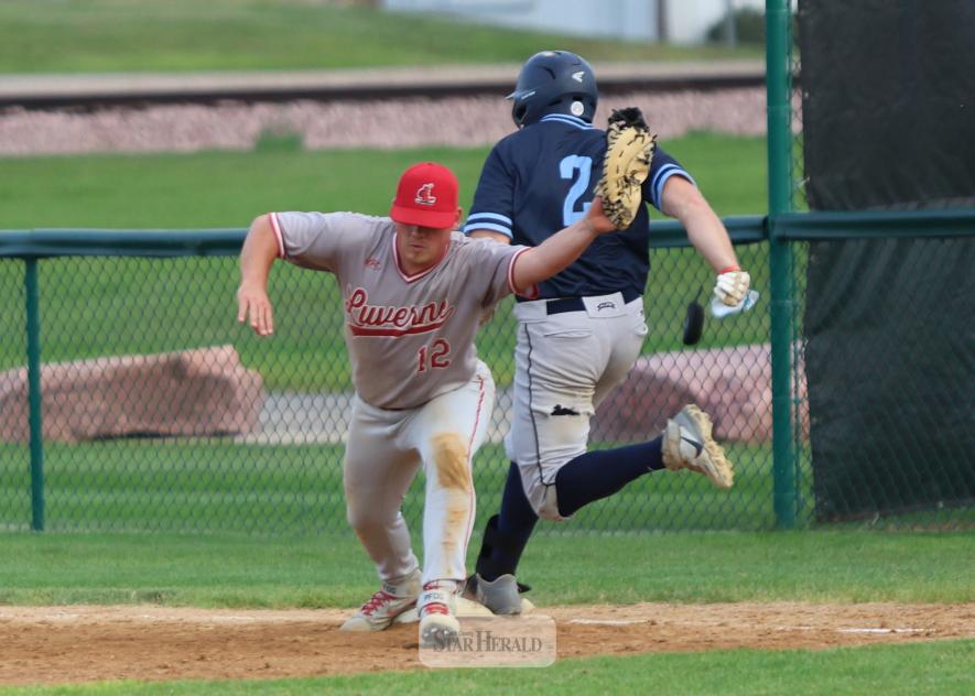 Redbird Skyler Wenninger stretches to make a catch before a Fairmont runner reaches first base Friday, July 25, In Luverne. The Redbirds fell 7-1 to the Martins in the game.