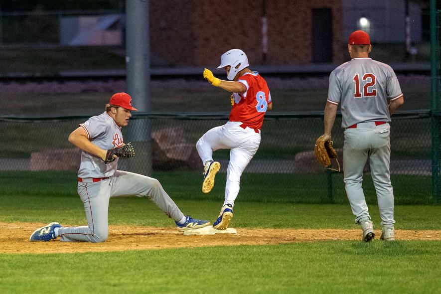 Greg Hoogeveen photo/Redbirds1 Redbirds first baseman Layke Miller touches first base just before a Heron Lake player for an out June 23 in Luverne. Pitcher Skyler Winninger watches the play unfold.