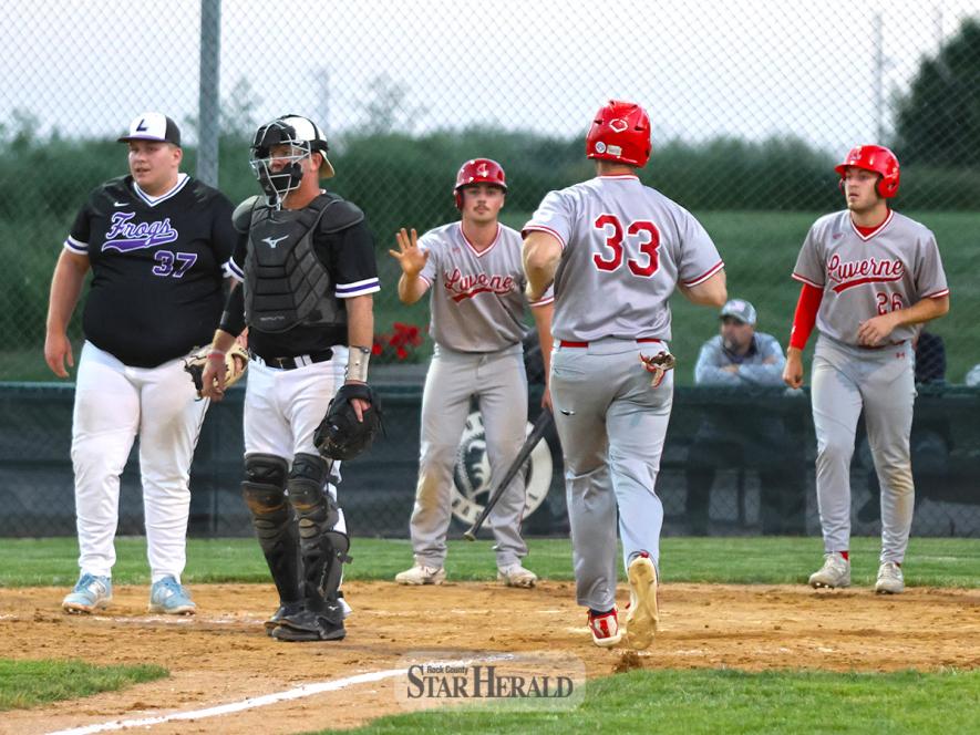 Newt Johnson, No. 33, strides to home plate as his teammates Casey Sehr and Cade Wenninger wait to congratulate him after scoring. Luverne beat Lakefield 10-0 at home June 5.