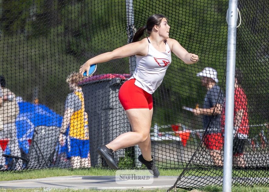 LHS senior Hannah Woodley, left, winds her way to the line to throw the discus at the Big South Conference meet in Luverne. 