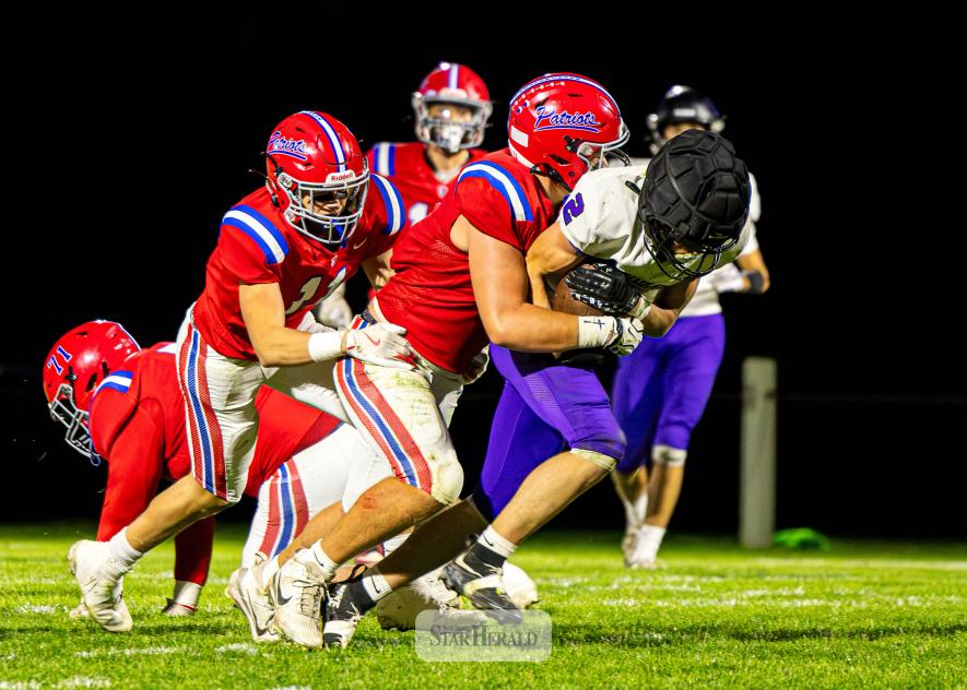 Samantha McGaffee photo/1008HBFB1 H-BC junior Karson Metzger wraps up a Mustangs player with the ball Friday, Oct. 2, on the road. THe Patriots beat GHECT 58-0 in the game.
