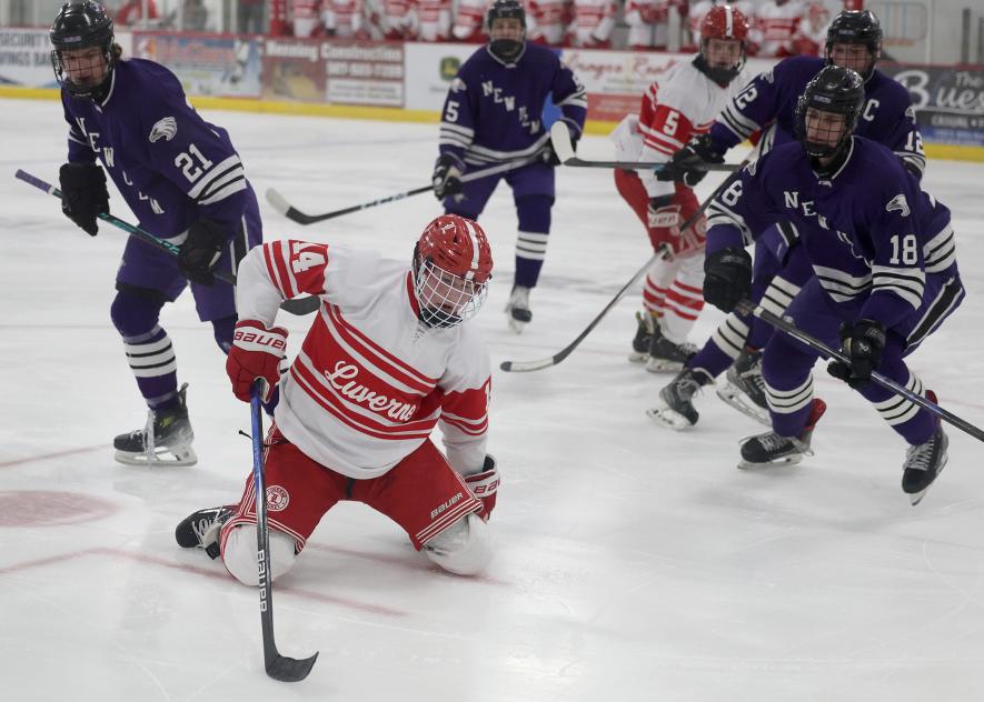 Greg Hoogeveen photo/lhsbhoc4 Luverne junior Ricky Rogers moves the puck towards the New Ulm net on his knees after being knocked down on the ice. Rogers finished with one goal against the Eagles Thursday, Feb. 12, in a LHS 6-3 win on home ice.