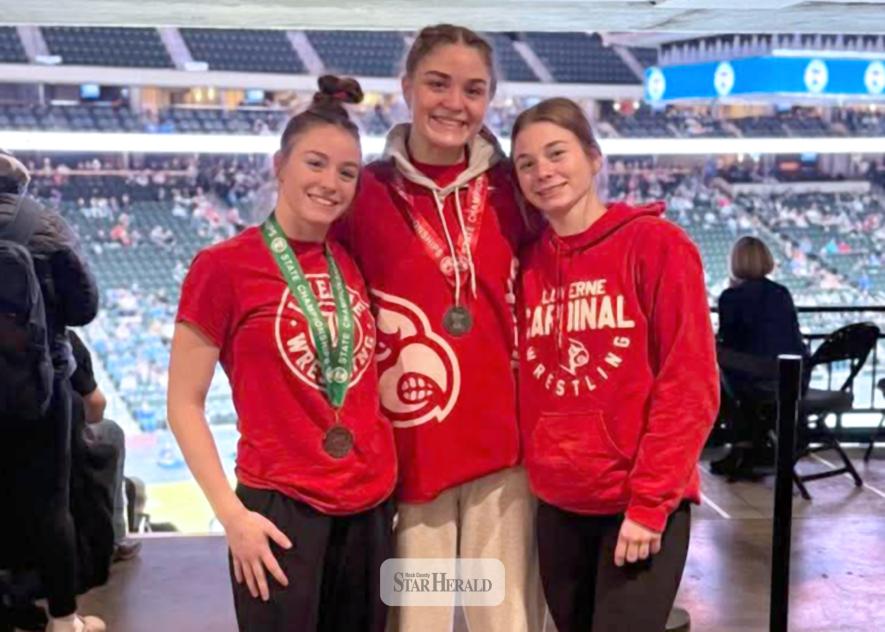 Rock sisters participate in the 2026 state wrestling tournament. Bernie, left, finishes in fifth-place and CeCe, center, ends taking second-place. Ellie, right, went 1-2 in her first time to state.
