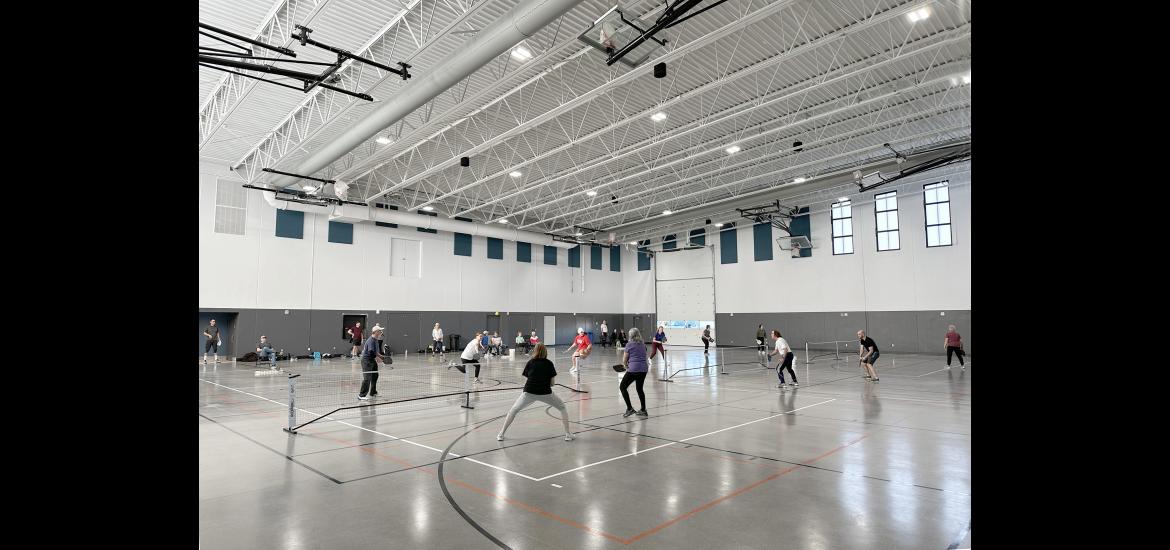 Five mornings a week, dozens of pickleball players gather in the National Guard Readiness Center assembly hall, which is divided into three courts to accommodate simultaneous games. Lori Sorenson/Rock County Star Herald Photo