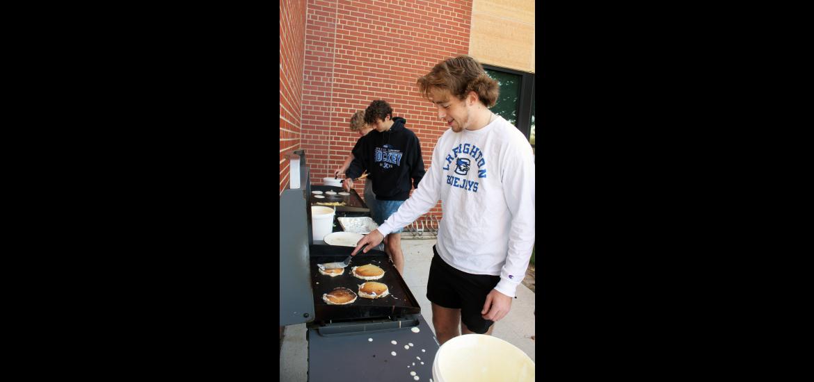 Luverne High School student council president Patrick Kroski grills pancakes with fellow seniors Tyler Arends (center) preparing scrambled eggs and Elliot Domagala also grilling pancakes. Mavis Fodness/Rock County Star Herald Photo