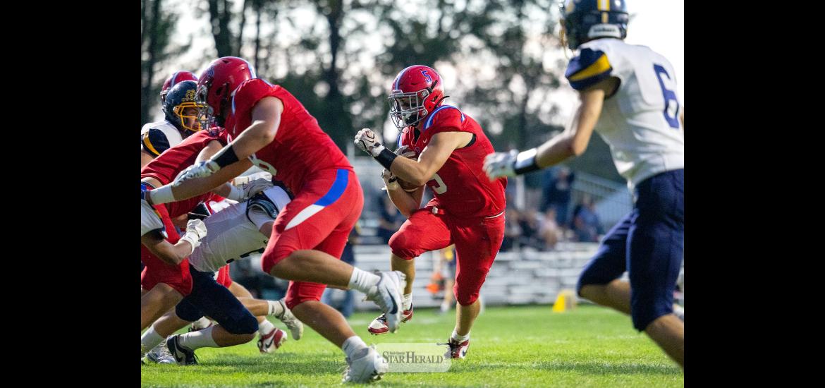 Greg Hoogeveen photo/0917HBCFB1 Patriots senior Riggins Rheault, No. 5, follows blockers to the end zone against Renville County West Friday, Sept. 11, at home. H-BC won the shortened game 38-6.  