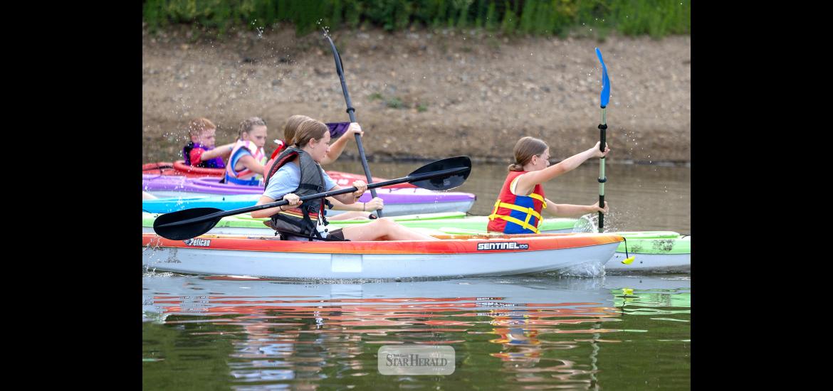 Greg Hoogeveen photo/DLT1 Left: Competitors in the Minnow race take off in kayaks in the first of a three legs in the 2026 Davis Lake Triathlon July 4 at The Lake in Luverne. The second leg was biking followed by running in the third leg that finished back at The Lake.