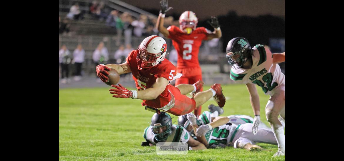 Greg Hoogeveen photo/1008LHSFB1 Cardinals senior Matthew Gangestad leaps into the end zone after breaking through three Pipestone players at the 3-yard line for a LHS touchdown. Luverne beat Pipestone 42-0 Friday, Oct. 2, at home in the annual Battle Axe contest.