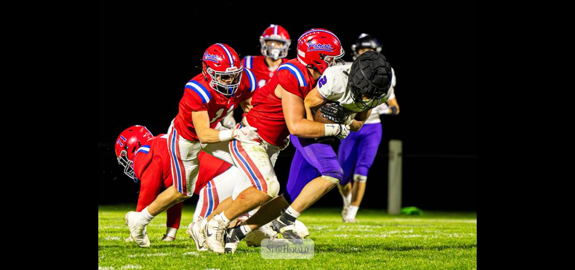 Samantha McGaffee photo/1008HBFB1 H-BC junior Karson Metzger wraps up a Mustangs player with the ball Friday, Oct. 2, on the road. THe Patriots beat GHECT 58-0 in the game.