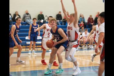Patriot senior Riley Tatge looks to the hoop after grabbing a rebound under the basket. H-BC beat WWG 61-48 in Hills Friday, Jan. 5.