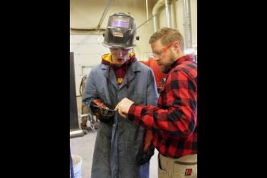 Blake Leenderts (left) and Power Mechanics instructor Chris Louwagie discuss the stick weld Leenderts completed. Mavis Fodness/Rock County Star Herald Photo