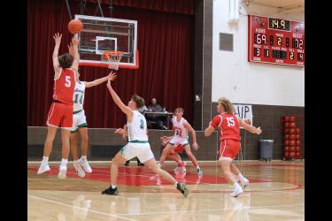 Junior Carter Sehr, No. 5, puts up a three-point shot with seconds left in regulation play against Pipestone. The shot found the net and the game went into overtime. In overtime the Arrows outplayed Luverne to win the game 87-80 Tuesday, Jan. 23, in Luverne.