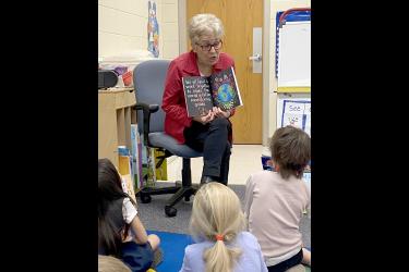 Shirley Harrison reads her children’s book, “We all Need,” to Jill Wagner’s elementary school classroom in December. She hopes to read to other classrooms this spring. Submitted Photo