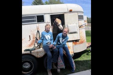 “Pony Pals” was developed by Kinley Dwire (left) and Afton Nuffer. The girls’ business centered around selling an experience of feeding treats to a horse and/or pony and learning about equines. Submitted Photo