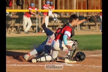 Redbirds player Casey Sehr slides into home plate during the game against Heron Lake Wednesday, June 26, in Worthington. Sehr was called out, but Luverne won the battle 4-0.
