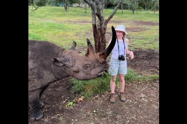 Sydney Biever feeds a blind black rhino in Africa