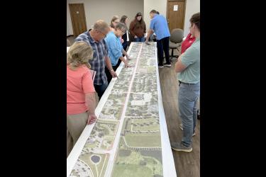 Attendees of the Aug. 28 meeting at the Trailhead building study an enlarged Highway 75 map showing details of construction stages. Lori Sorenson/Rock County Star Herald Photo
