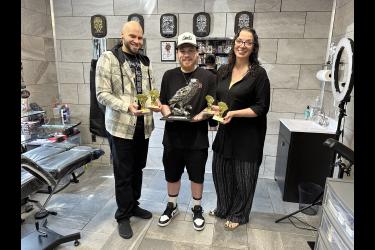 Conspiracy Tattoo operators Christina and Tony Perez are pictured with their friend and colleague, Donovan Conklin, who designed (and wears) one of the Tony’s winning tattoos.Rock County Star Herald Photo/Lori Sorenson