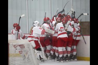 The Luverne girls’ hockey team rushed freshman Tenley Behr after her game-winning goal in overtime. The Cardinals beat Mankato East 4-3 at home Saturday, Dec. 9, after coming back from a 3-0 deficit.