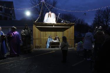 Ava Lafrenz takes in the manger scene. Mavis Fodness/Rock County Star Herald Photo