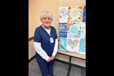 Carol Wieneke of Luverne stands beside a quilt last week that honors her 60 years on the job with Sanford Health. Written on the quilt are messages “No matter how difficult the days may get, never forget the reason you become a nurse,” “Best Nurse Ever,” and “May you be proud of the work you do, the person you have become and the difference you make.” Wieneke’s last day on the job is Friday, Dec. 29. Submitted Photo
