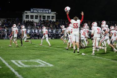 Luverne players rush the Huskies’ field after beating Jackson County Central 36-30 in Week 7 action.