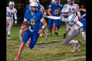 Rock County Star HerSkyler Jackson photo/AEFB1 A-E senior Charger Erlandson slips past several Nicollet players Oct. 14 at home. The Dragons beat the Raiders 60-6.ald Photo