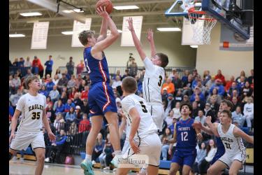 Greg Hoogeveen photo/HBCBBB5 Patriot sophomore Brodie Metzger goes vertical for a shot at the hoop against the Eagles Friday, Jan. 23, in Hills. Metzger finished with 16 points and four rebounds in the 71-50 win against Southwest Minnesota Christian.