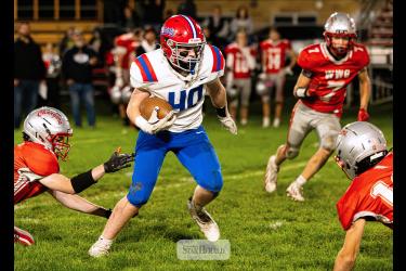 Samantha McGaffee photo/H-BCFB1 H-BC freshman Huck Terry weaves his way through several Chargers players on the road Friday, Sept. 25. H-BC won the game 55-6. Terry rushed for 55 yards and one touchdown.