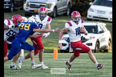 Samantha McGaffee photo/0910 HBC/AEfootball1 H-BC junior Brodie Metzger, No. 10,  finds an edge against the Dragons. Adrain-Ellsworth junior Cael Schettler , No. 88, reaches to try and grab Metzger on the play.