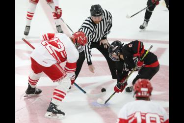 Senior Elliot Domagala takes the opening faceoff against Redwood Thursday, Jan. 11, in Luverne.The Cardinals won the game 14-0. Luverne is now 13-0 for the regular season.
