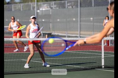Greg Hoogeveen photo/0924LHSTennis1 LHS sophomore Makenzie Smith, foreground, and eighth-grader Ashlyn Hemme prepare for a return by Blue Earth in No. 3 double action in Luverne Sept. 15. 