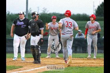 Newt Johnson, No. 33, strides to home plate as his teammates Casey Sehr and Cade Wenninger wait to congratulate him after scoring. Luverne beat Lakefield 10-0 at home June 5.