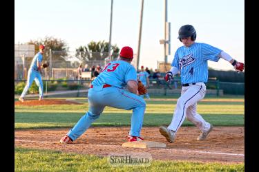  Jake Haugen and Newt Johnson try to pick off a Tea player at first base Friday, May 24.