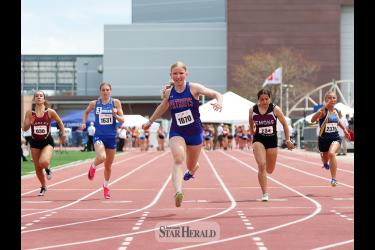 Rock County SH-BC freshman Brynn Bakken, center No. 1070, finishes her prelim 100-meter race in first place with a time of 12.30 on Friday, May 3, at the 99th Annual Howard Wood Dakota Relays in Sioux Falls. Bakken took first place in the finals on Saturday, May 4, with a time of 11.98.tar Herald Photo